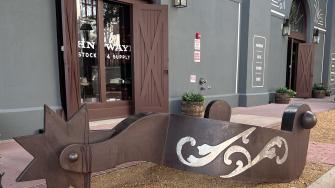 Large metal sculpture shaped like a cowboy spur.